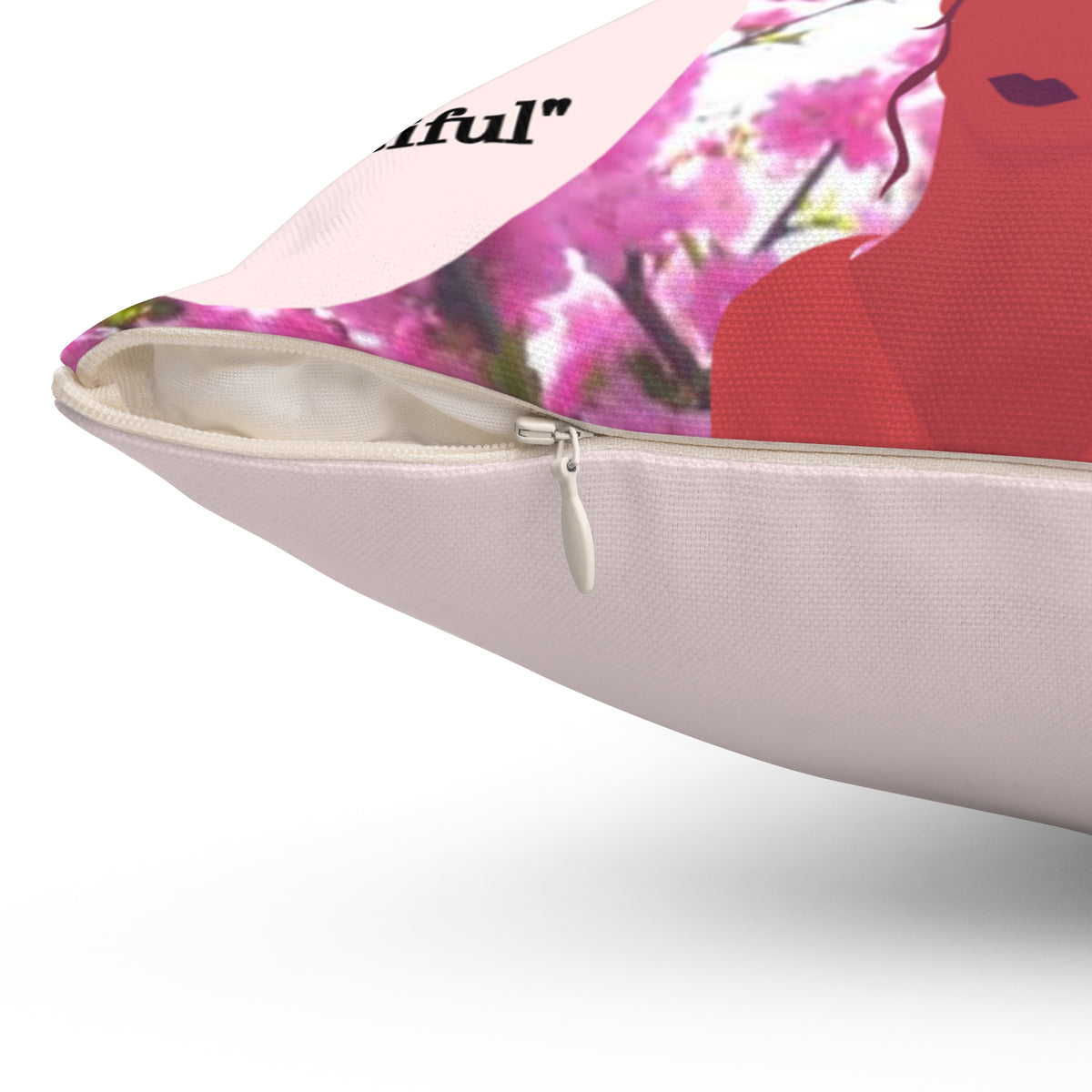 Pink polyester throw pillow with a concealed zipper, featuring a woman's silhouette and floral design.