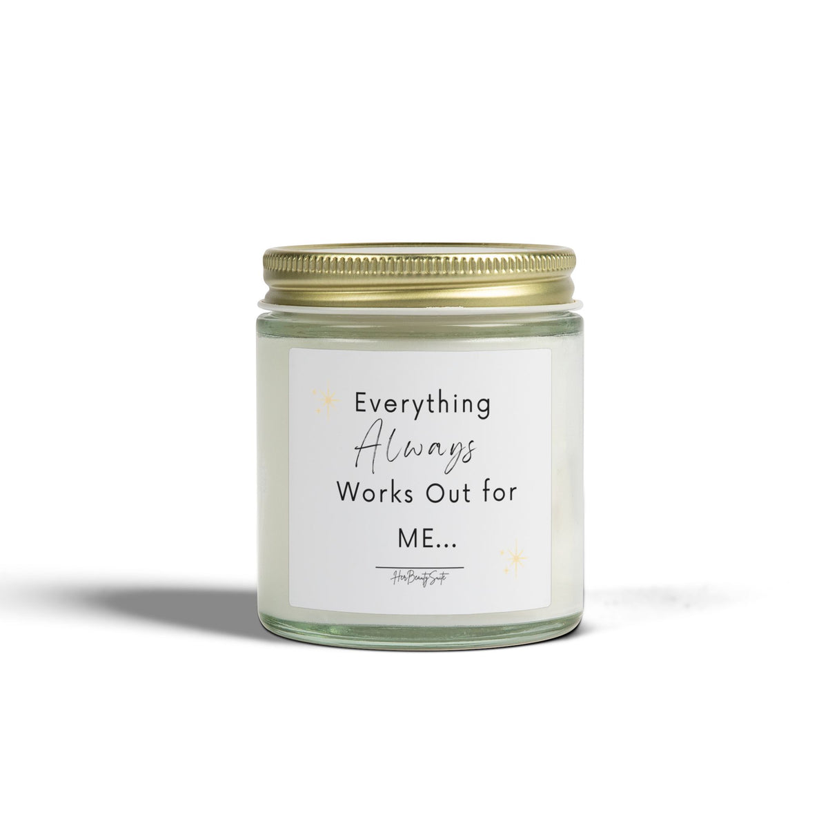 White soy candle in a clear glass jar with a gold lid, featuring 