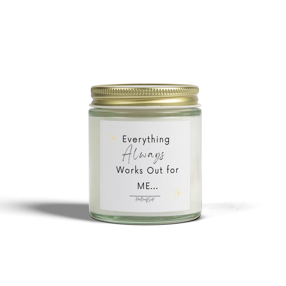 White soy candle in a clear glass jar with a gold lid, featuring 