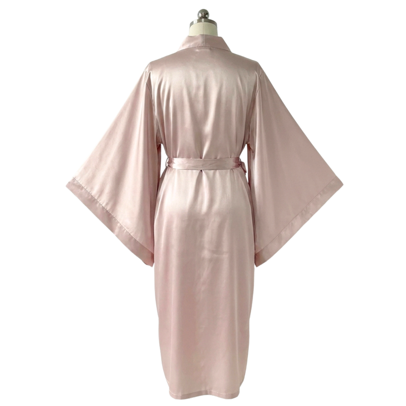 Long silky pink satin kimono robe with wide sleeves and an adjustable waist tie, displayed on a mannequin.