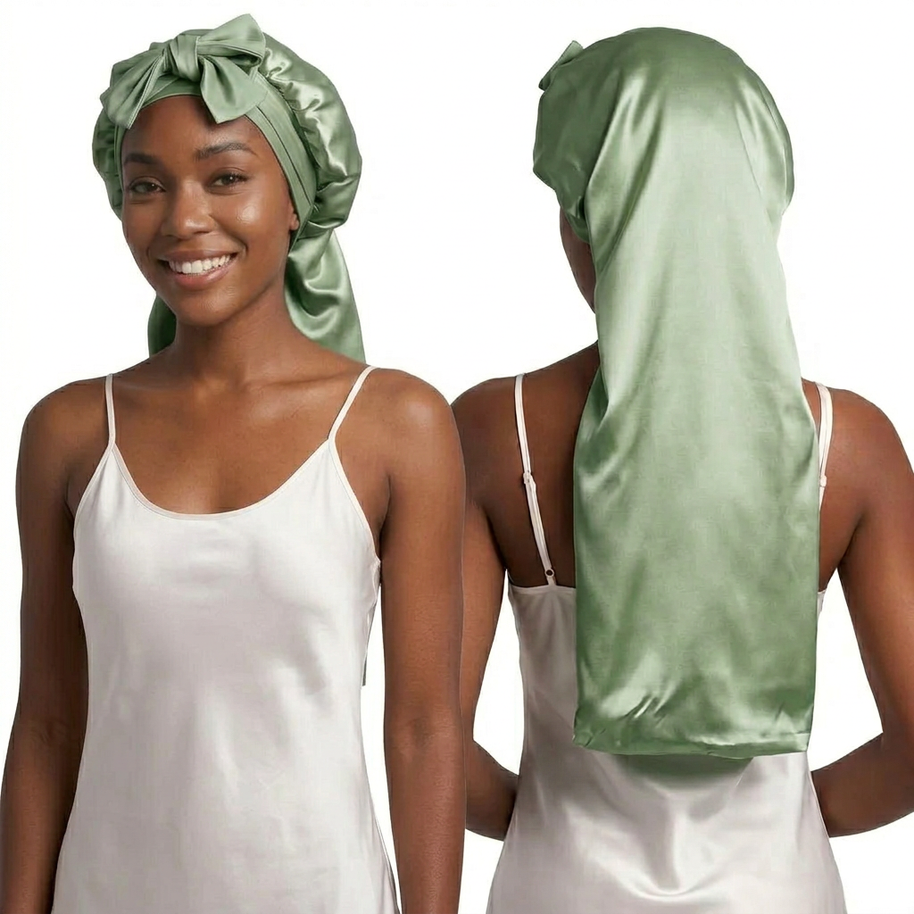 Smiling woman wearing a long sage green mulberry silk bonnet with ties, front and back view.