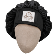 Black double-layered mulberry silk bonnet with an adjustable non-slip band and Her Beauty Suite logo on a mannequin head.