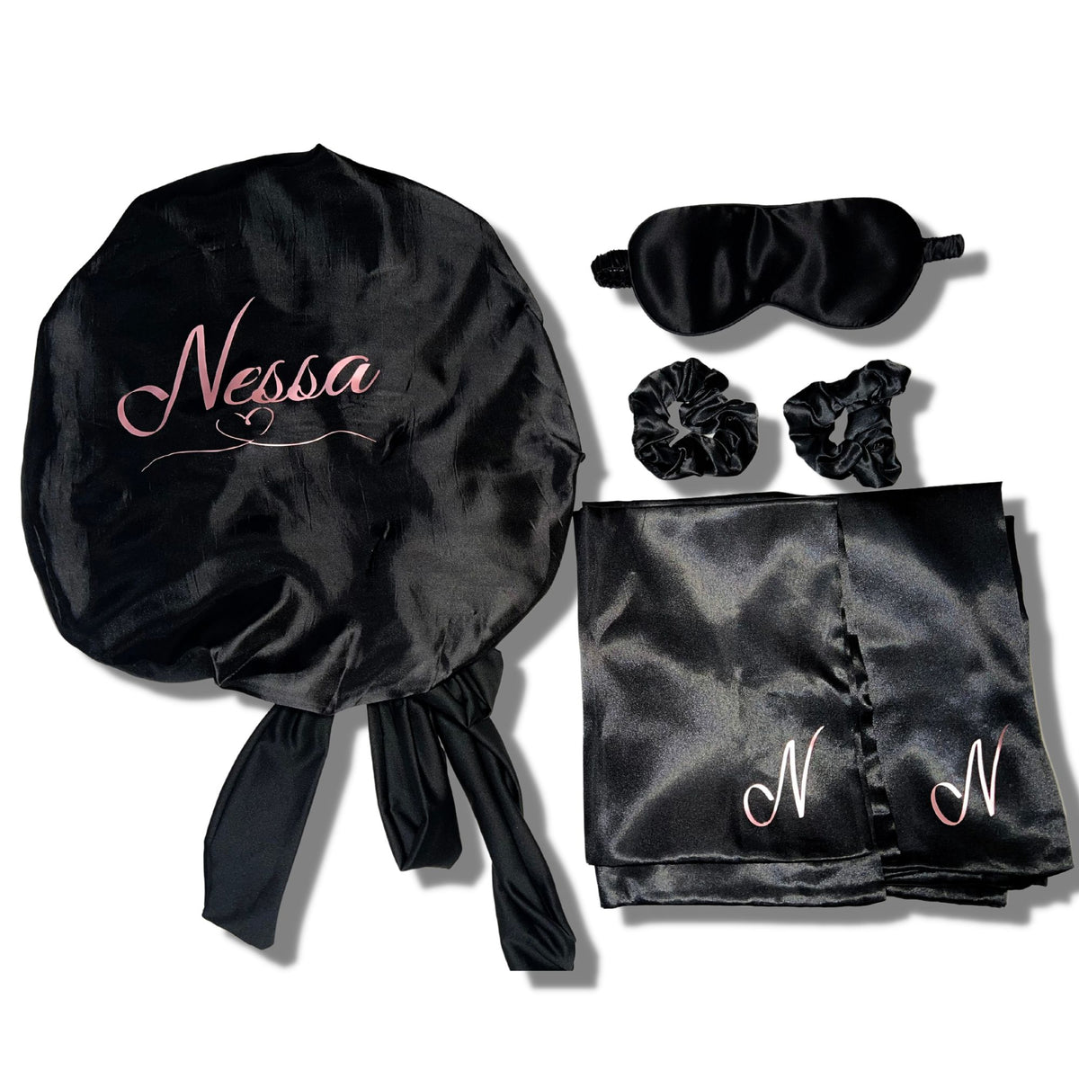 Black satin bonnet, eye mask, two scrunchies, and pillowcase with pink 