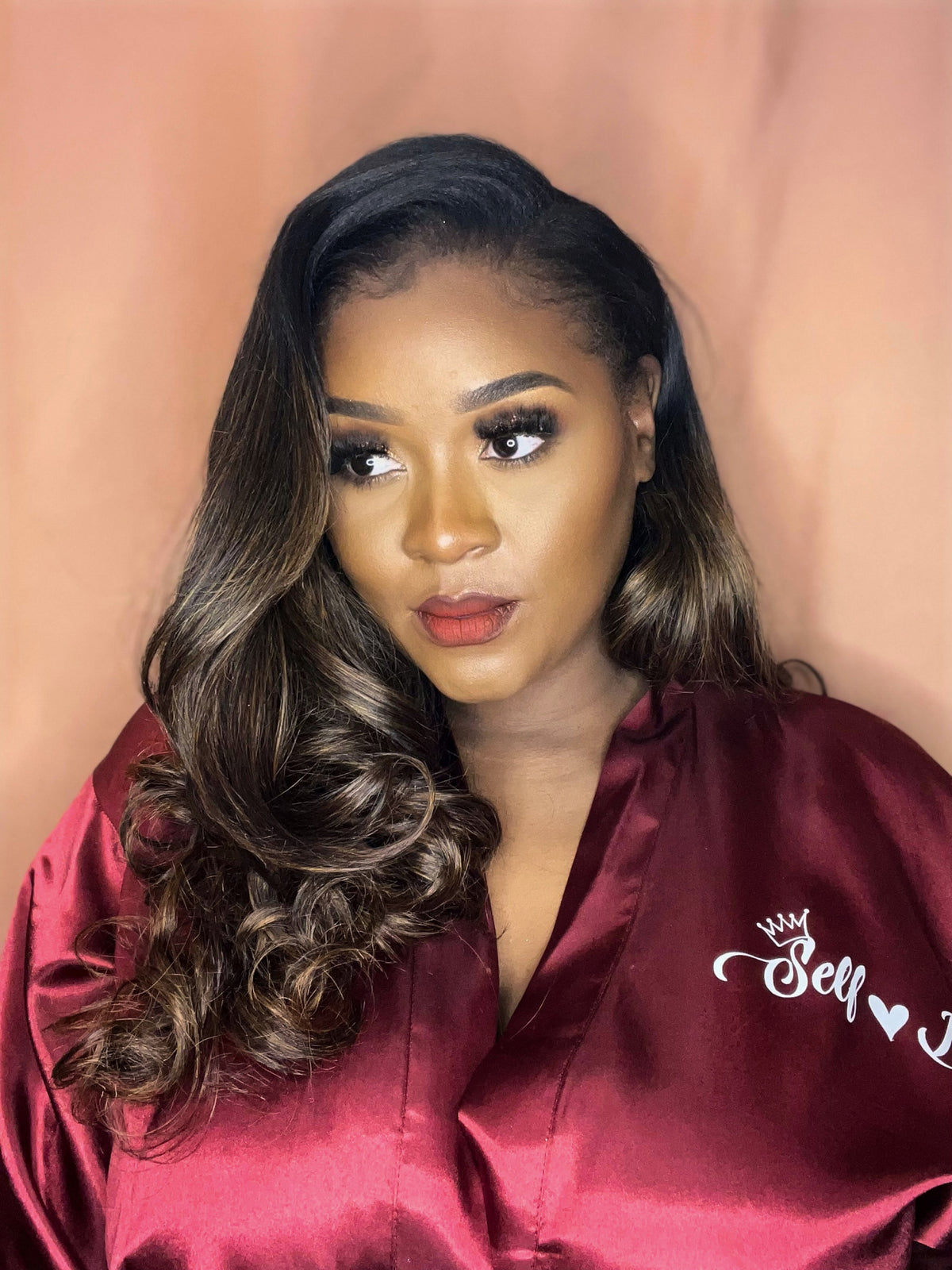 Woman wearing a custom burgundy satin robe with 